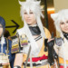 Three people in colorful costumes dressed as anime heroes posing together.